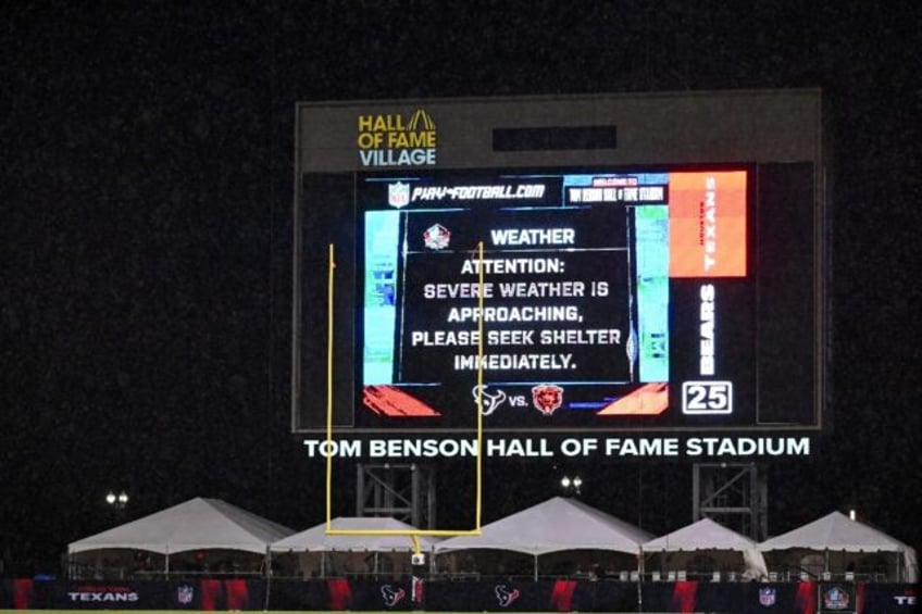 The scoreboard at the NFL's first pre-season game between Houston and Chicago warns of the