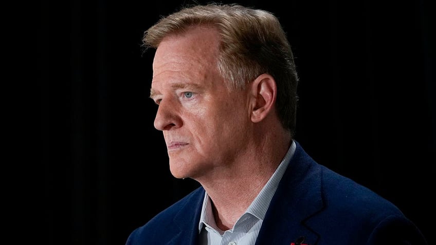 Roger Goodell looks on