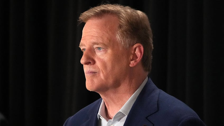 Roger Goodell looks on