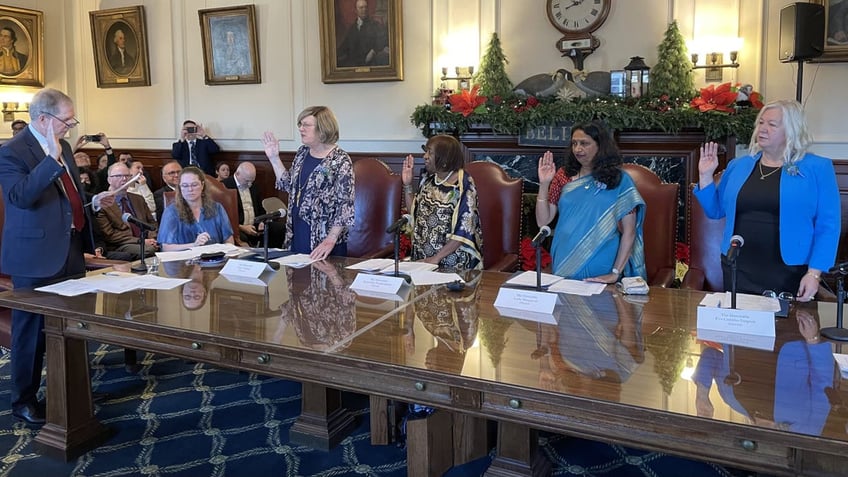 New Hampshire's four electors are sworn in by Secretary of State Dave Scanlon, left, as the Electoral College vote takes place in state capitols across the country, in Concord, New Hampshire, on Dec. 17, 2024.