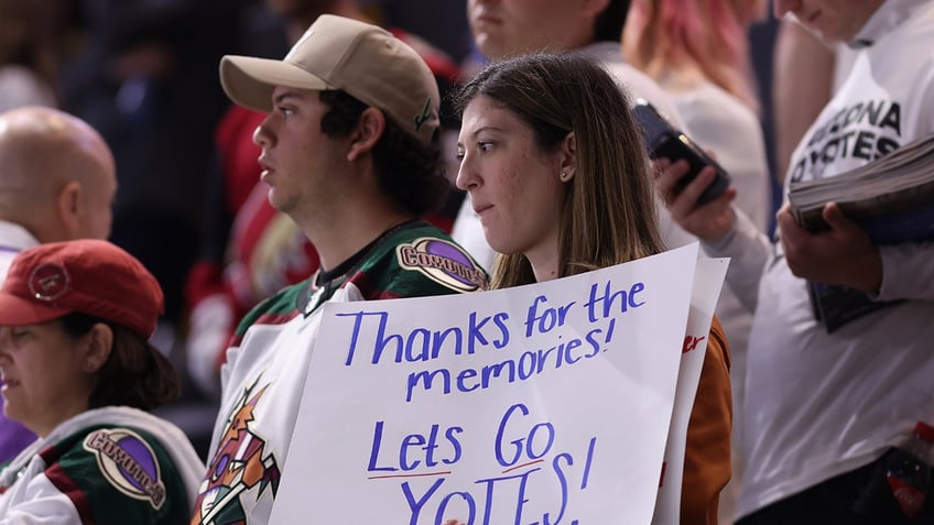 Coyotes fans look on ice