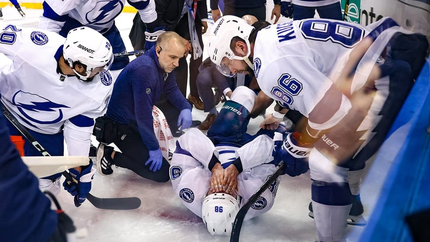 Mikhail Sergachev is treated on the ice