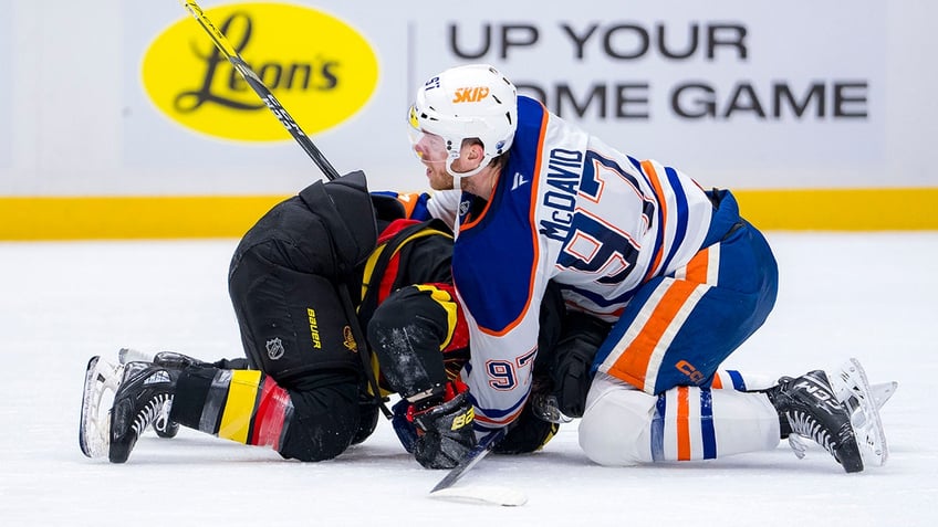 Connor McDavid battles with Conor Garland