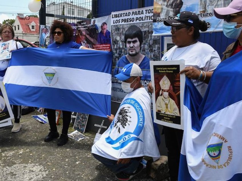 Nicaraguan citizens hold a demonstration in front of the Nicaraguan Embassy in Costa Rica to protest against the Nicaraguan government and the detention of Nicaraguan bishop and regime critic Rolando Alvarez, in San Jose, on August 19, 2022. - Nicaraguan police on August 19, 2022 forcefully removed Catholic bishop and government critic Rolando Alvarez from his official residence after two weeks under siege, said Church and rights groups who had no news on his whereabouts. (Photo by Oscar Navarrete / AFP) (Photo by OSCAR NAVARRETE/AFP via Getty Images)