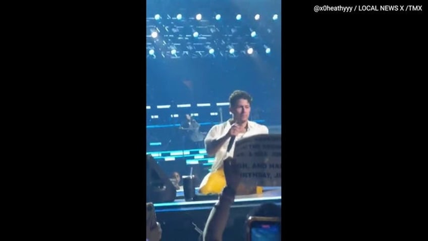 nick jonas falls into a hole while performing at jonas brothers concert