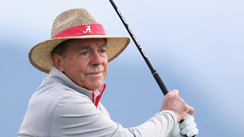 Nick Saban playing golf