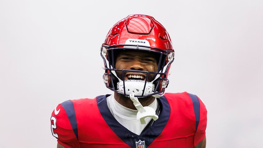 Nico Collins smiles on field