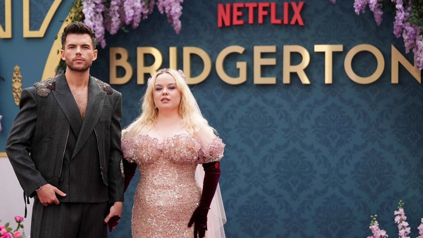 'Bridgerton' stars Luke Newton, left, and Nicola Coughlin, right, arrive at the season three part two screening of Netflix's 'Bridgerton' in London.