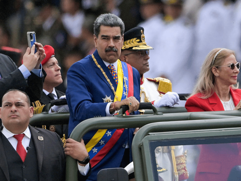 Venezuela's President Nicolas Maduro and First Lady Cilia Flores parade in a military vehi