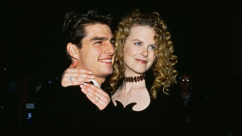 Nicole Kidman wraps her arms around Tom Cruise