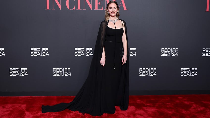 Emily Blunt wore a black Gucci gown with a draping cape to the Women In Cinema - Red Sea International Film Festival 2024