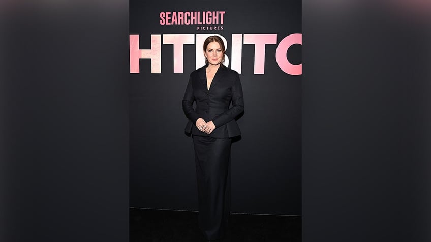 Amy Adams at the premiere of Nightbitch, in a black suit jacket and matching skirt.