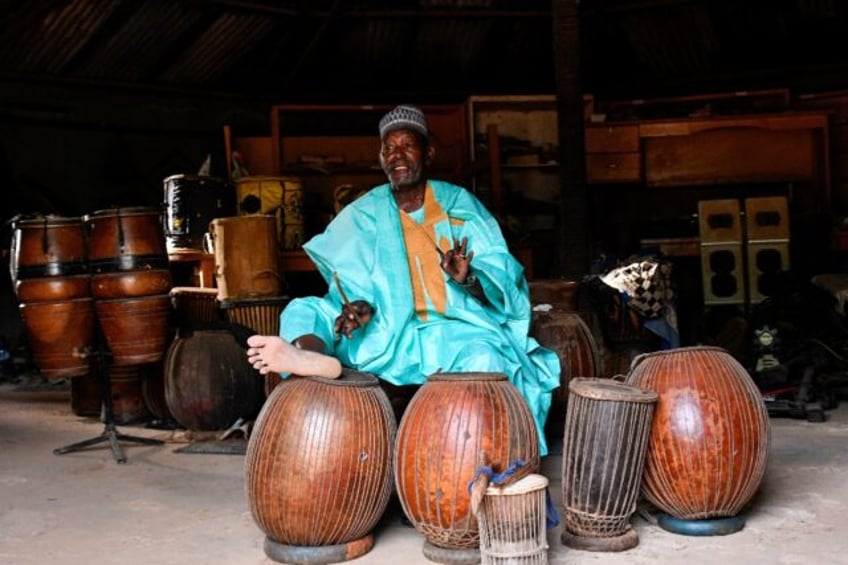 Oumarou Adamou, alias Maidouma, is a master of the douma, which he plays with sticks and by rotating his bare foot on its goatskin membrane