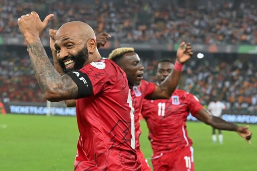 Equatorial Guinea captain Emilio Nsue (L) celebrates his second goal against Ivory Coast