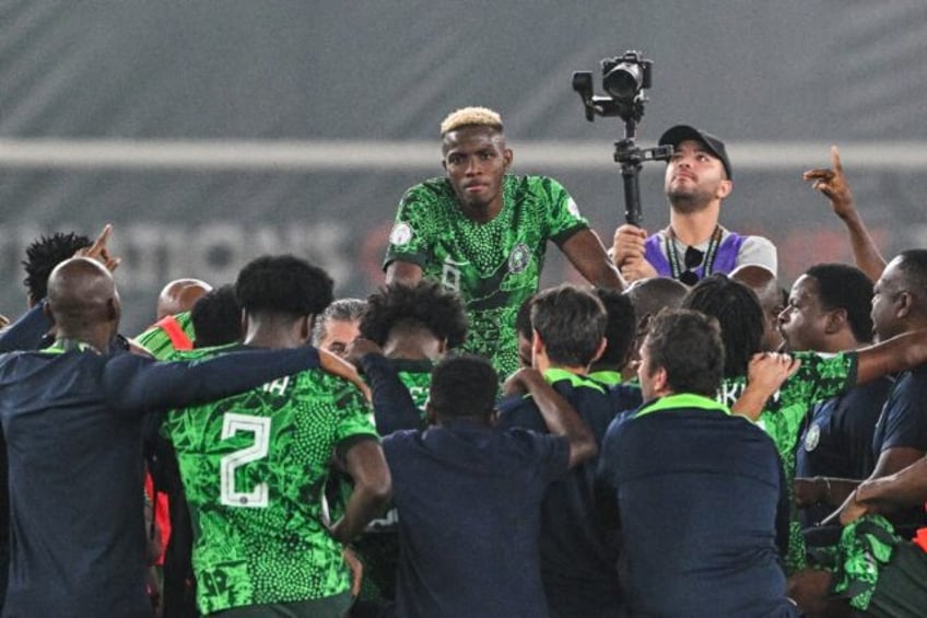 Victor Osimhen (C) and teammates celebrate after Nigeria reached the Africa Cup of Nations