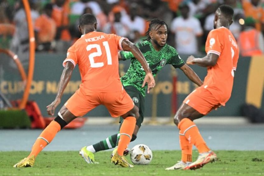 Nigeria star Ademola Lookman (C) takes on two Ivory Coast defenders during the 2024 Africa