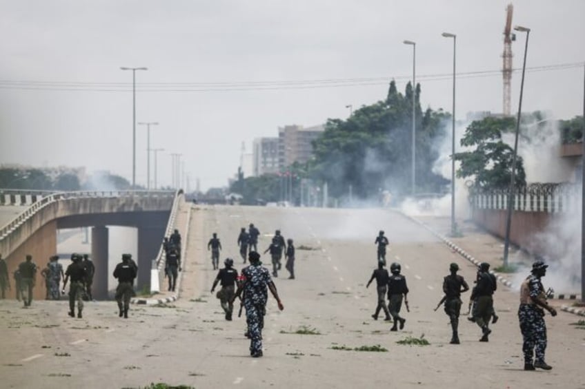 Nigerian security forces fire tear gas during the protests in Abuja