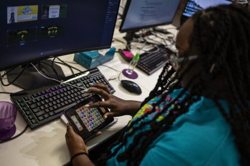 A worker plays a video game in Maliyo office in Lagos on January 20, 2025