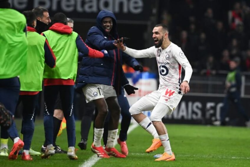 Nabil Bentaleb (R) runs to the sideline to celebrate his comeback goal with Lille substit