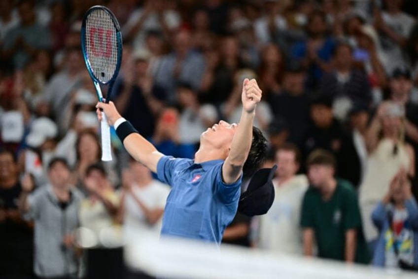 Japan's Kei Nishikori celebrates after his five-set victory against Brazil's Thiago Montei