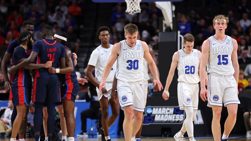 BYU players walk with heads down