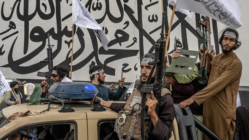 Taliban fighters in truck with guns