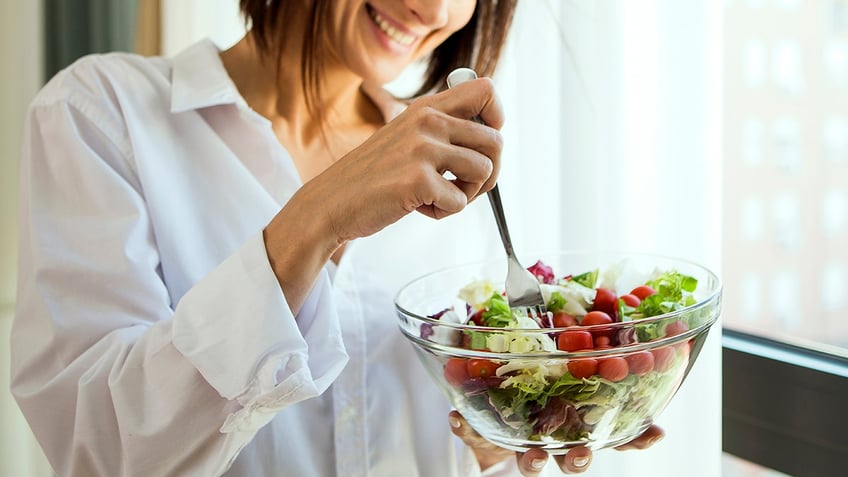 Woman eating salad