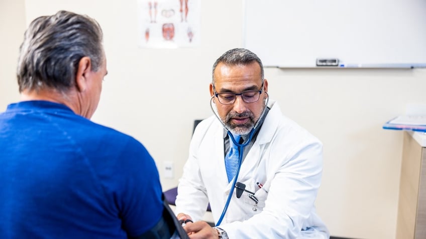 Doctor taking blood pressure