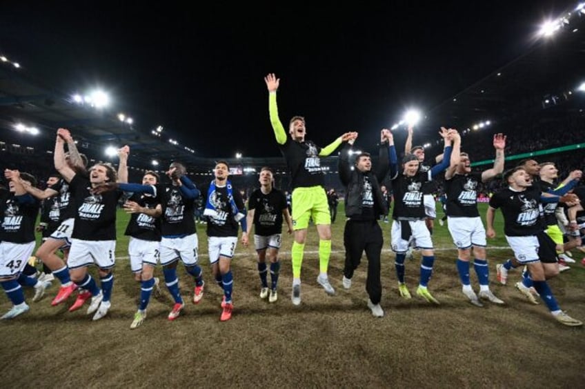 Arminia Bielefeld players celebrate after defeating Bayer Leverkusen to make the German Cu