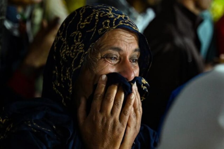 A woman cries as she waits outside a clinic after landslides in Wayanad district India's K