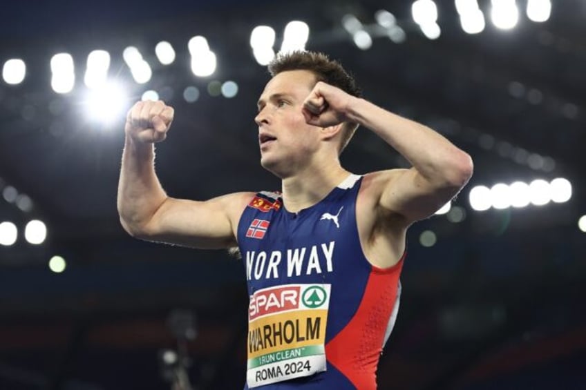 Karsten Warholm celebrates winning gold at the European Athletics Championships in June