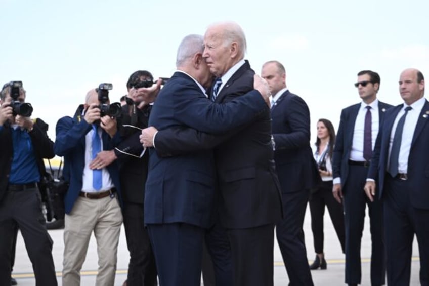 Israel Prime Minister Benjamin Netanyahu hugs US President Joe Biden upon his arrival at T