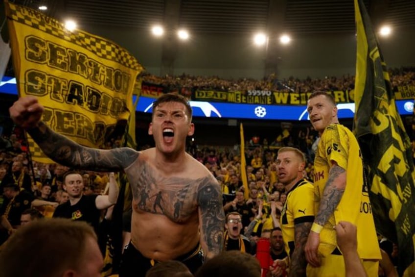 Marco Reus (R) celebrates Borussia Dortmund reaching the Champions League final with fans