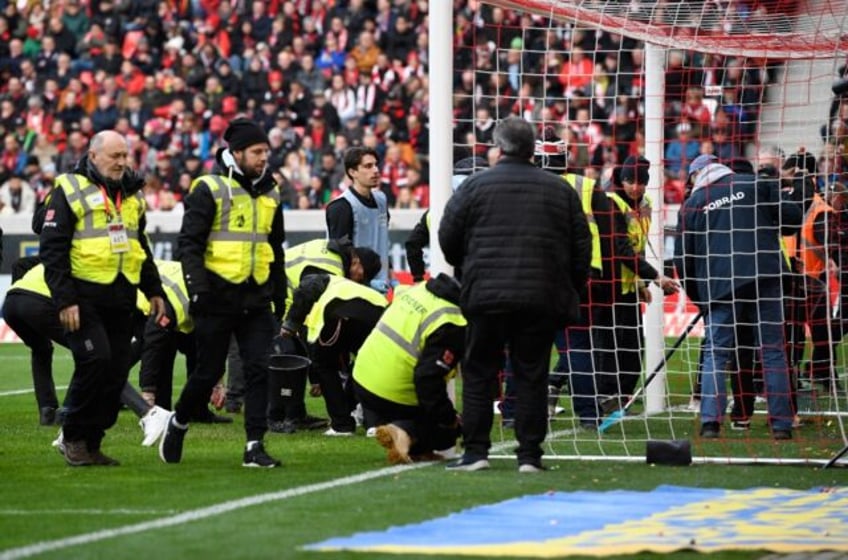 Dozens of football games in Germany have been delayed by tennis balls and foil-covered coi