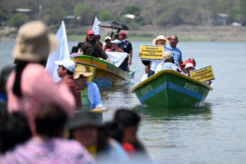 Activists from El Salvador, Guatemala and Honduras hold a protest on Lake Guija against a