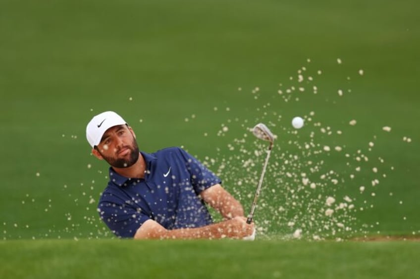 World number one Scottie Scheffler of the United States blasts out of a bunker during a pr