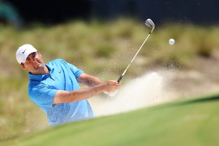 World number one Scottie Scheffler of the United States blasts out of bunker on the 15th h