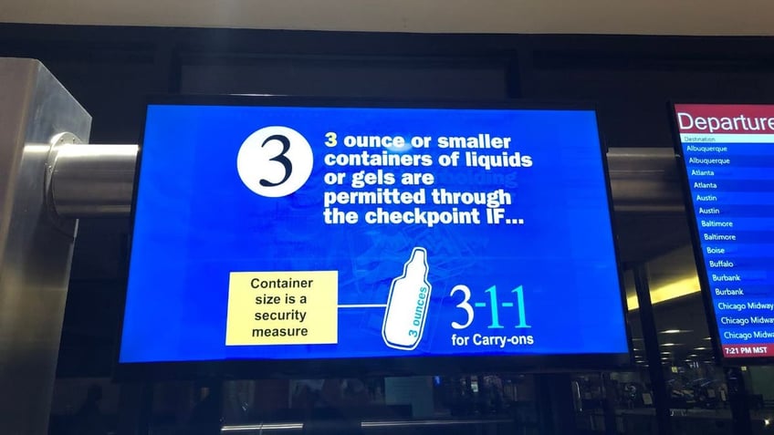 3.4 ounce liquid sign in an airport
