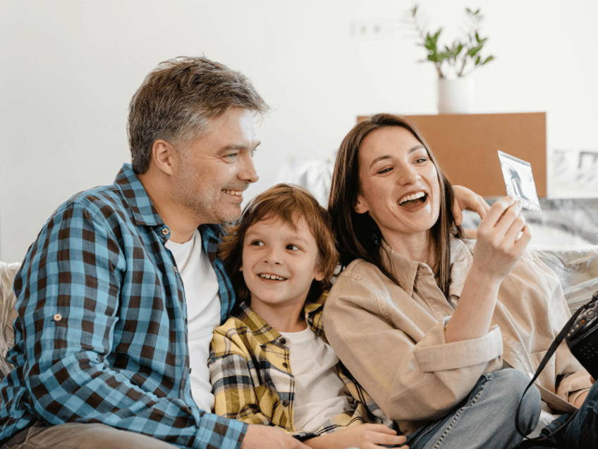 man woman and child smiling