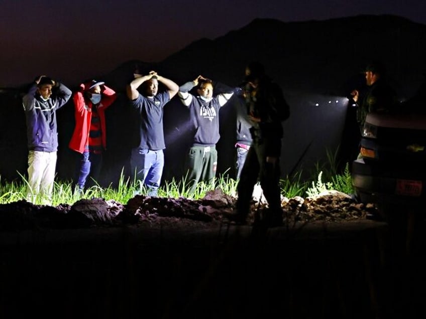 YUMA, ARIZONA - MAY 22: Immigrants who were apprehended on farmland near the U.S.-Mexico b