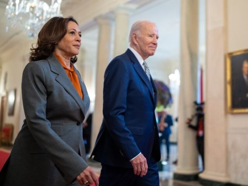 President Joe Biden and Vice President Kamala Harris walk through the Cross Hall as they a