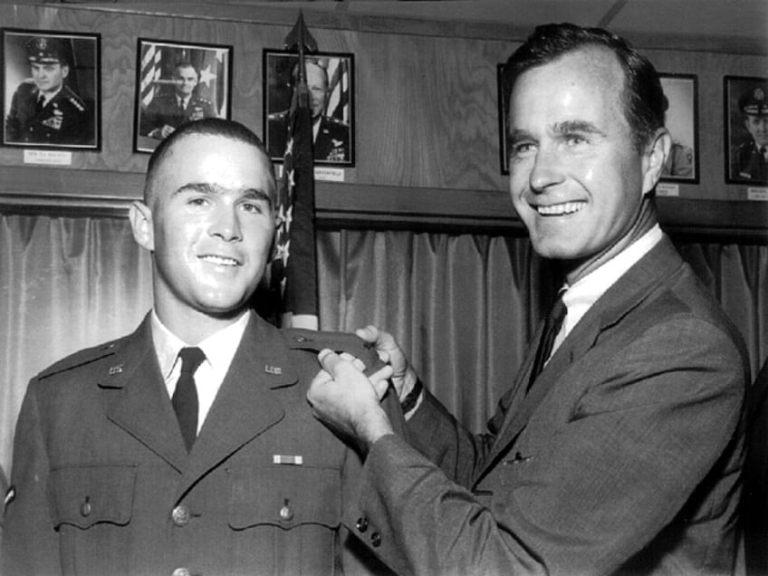 File Photo: George Bush, Sr. (Right) Proudly Displays The Officer's Bar Of 2Nd Lt. George W. Bush Of The Texas Air National Guard During A Special Ceremony Where Bush Was Sworn Into The Air National Guard Circa 1968. (Photo By Getty Images)