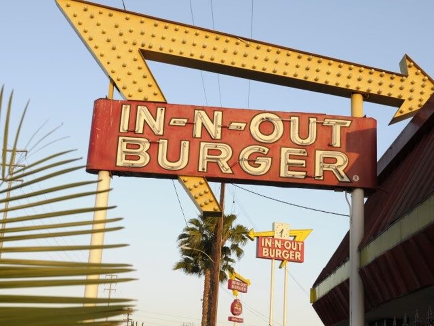 In-N-Out Burger signs, two in the foreground from the fast food chain's original location, and one in the background at a new location across the Interestate 10 freeway, fill the skyline on Tuesday, June 8, 2010, in Baldwin Park, Calif. (Adam Lau/AP)