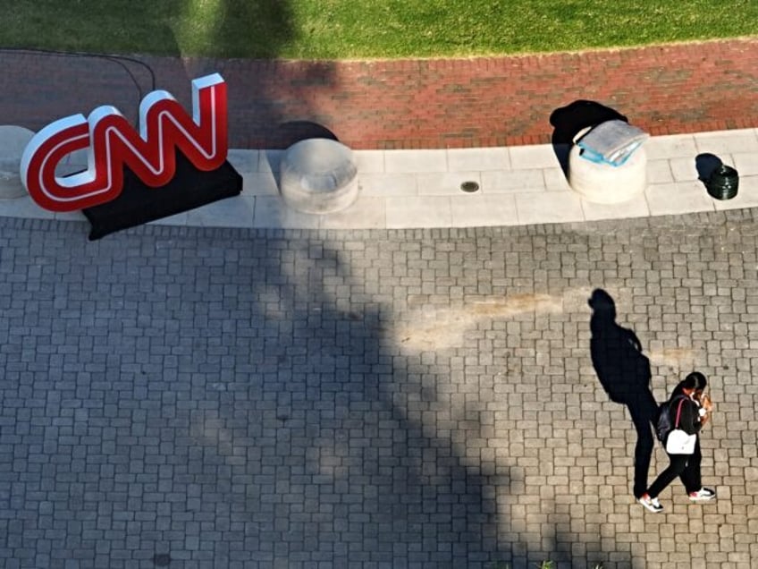 ATLANTA, GEORGIA - JUNE 26: In an aerial view, a person walks past a CNN logo outside of t