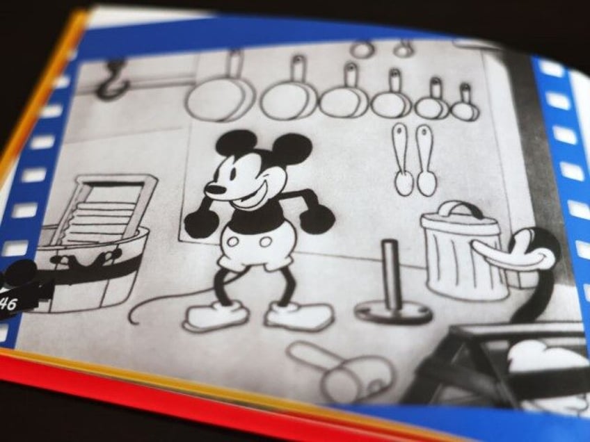 In this photo illustration, a still from Disney's 'Steamboat Willie' that was the debut of Mickey Mouse is seen in a book on January 05, 2024 in Los Angeles, California. As of New Year's Day, the copyright for the earliest Mickey Mouse iteration 'Steamboat Willie' has expired, entering the public …