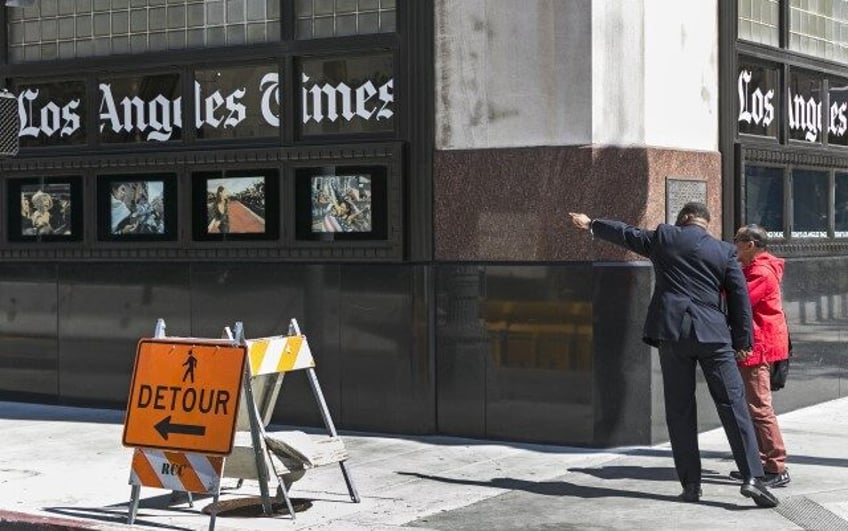 A pedestrian asks for directions outside the Los Angeles Times building in downtown Los Angeles, Monday, April 25, 2016. Newspaper publisher Gannett said Monday that it wants to buy rival Tribune Publishing in a deal that would give the owner of USA Today control of the Los Angeles Times, Chicago …