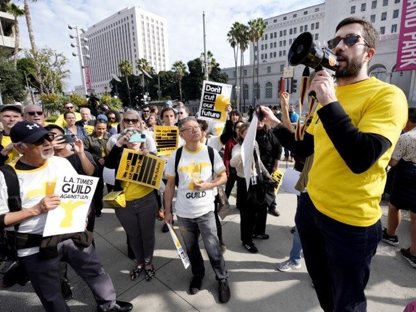 Matt Hamilton, an investigative reporter for the Los Angeles Times, talks to staff and supporters during a rally in downtown Los Angeles on Friday, Jan. 19, 2024. Guild members of the Los Angeles Times participated in one-day walkout to protest imminent layoffs. The job action Friday is the first newsroom …