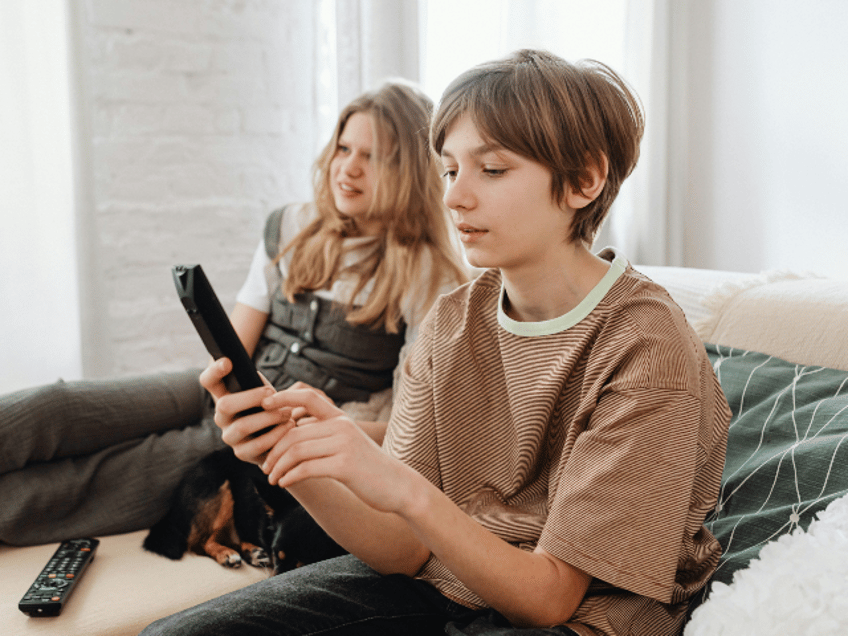 A Boy Holding a TV Remote