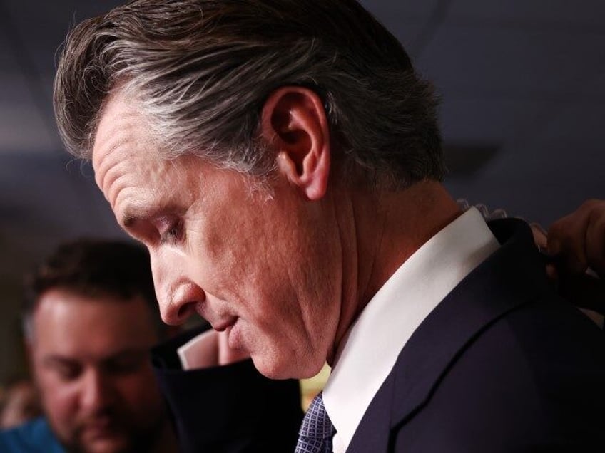 California Gov. Gavin Newsom prepares for an interview in the spin room following the FOX