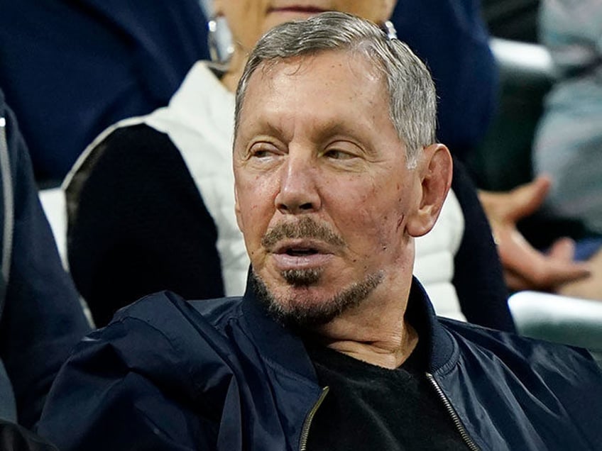 Larry Ellison, chairman of Oracle Corporation and chief technology officer, watches from t